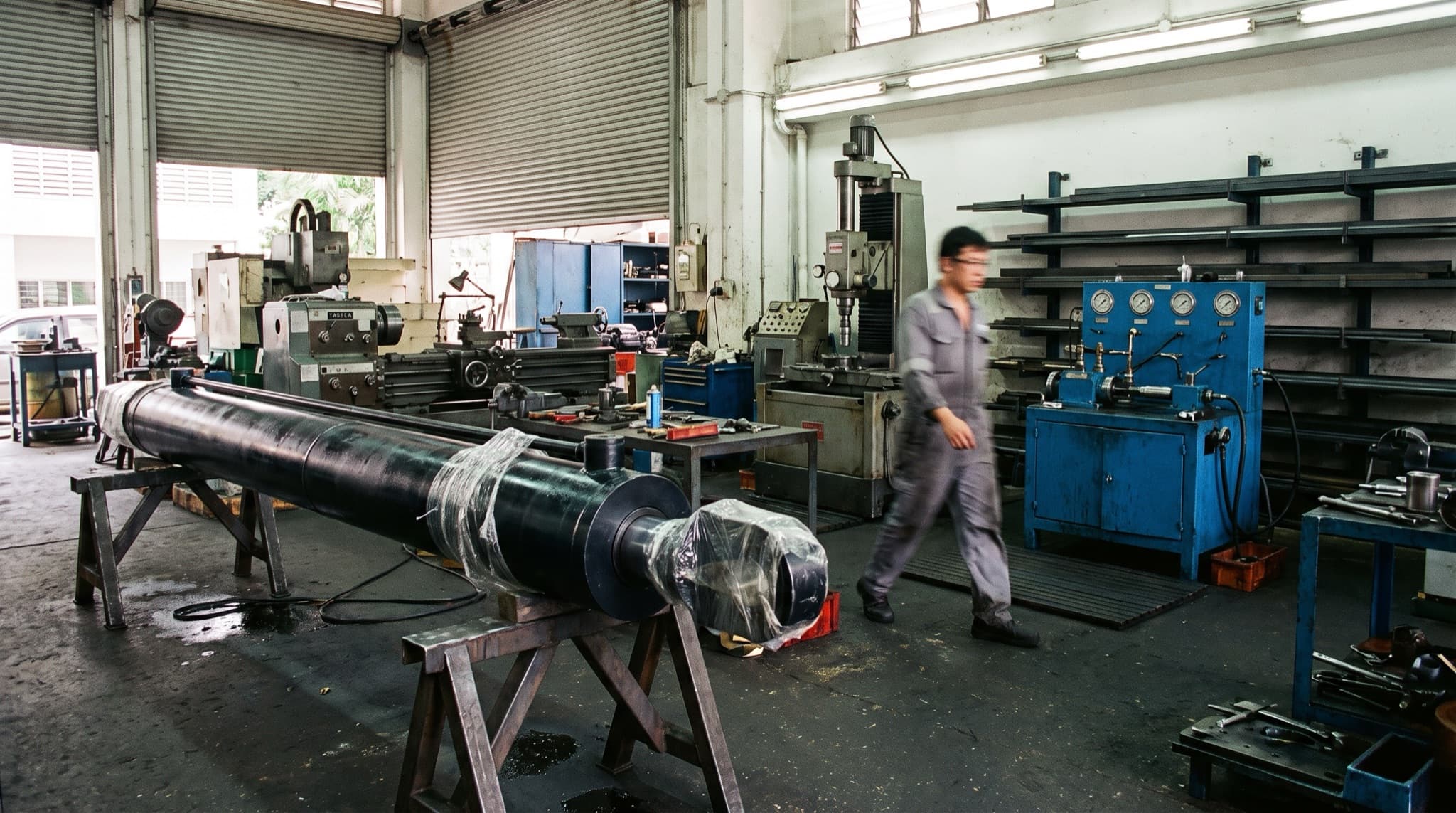 Large industrial hydraulic cylinder laid out in the workshop
